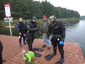 Zdjęcie kolorowe. Policjanci podczas przygotowań do zajęć nurkowania