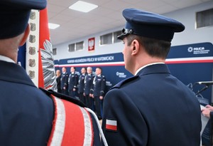 Zdjęcie przedstawia zbliżenie na policjanta stojącego w poczcie sztandarowym