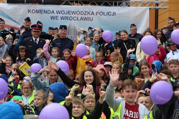 dzieci i policjanci znajdują się na płycie przed dworcem kolejowym i korzystają z atrakcji przygotowanych przez policjantów z dolnego śląska