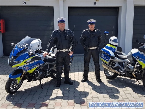 Policjanci stoją przy motocyklach