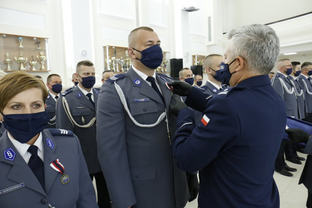 Komendant Wojewódzki Policji wręcza odznaczenie funkcjonariuszowi.