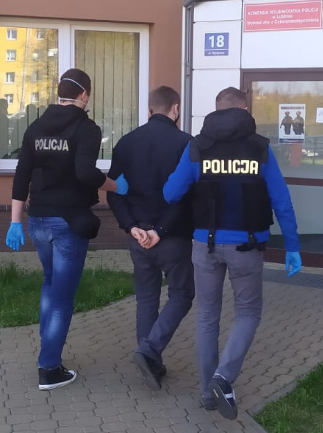 Policjanci prowadzą zatrzymanego.