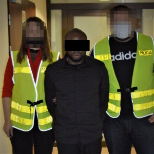 zatrzymany ob. Nigerii obok policjanci