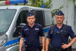 policjanci na tle radiowozu