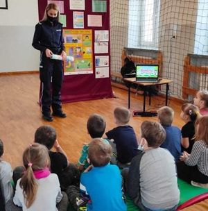 policjantka stojąca przed grupa dzieci