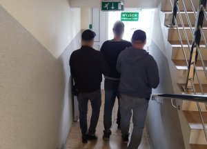 trzej mężczyźni schodzący po schodach