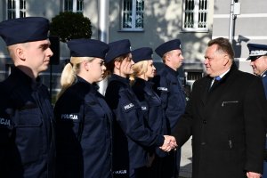 Wiceminister i komendant wojewódzki gratulują policjantom.