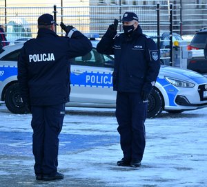 policjanci stoją obok siebie i oddają honory