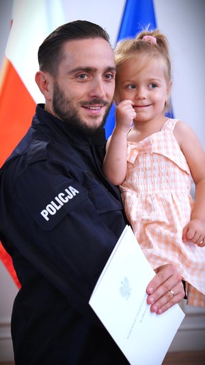Zdjęcie: policjant z dzieckiem.