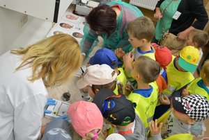 policjantki z laboratorium odbijają na karteczkach odciski palców dzieci