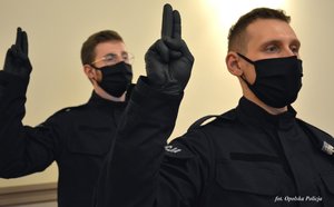 2 policjantów z uniesioną dłonią do ślubowania